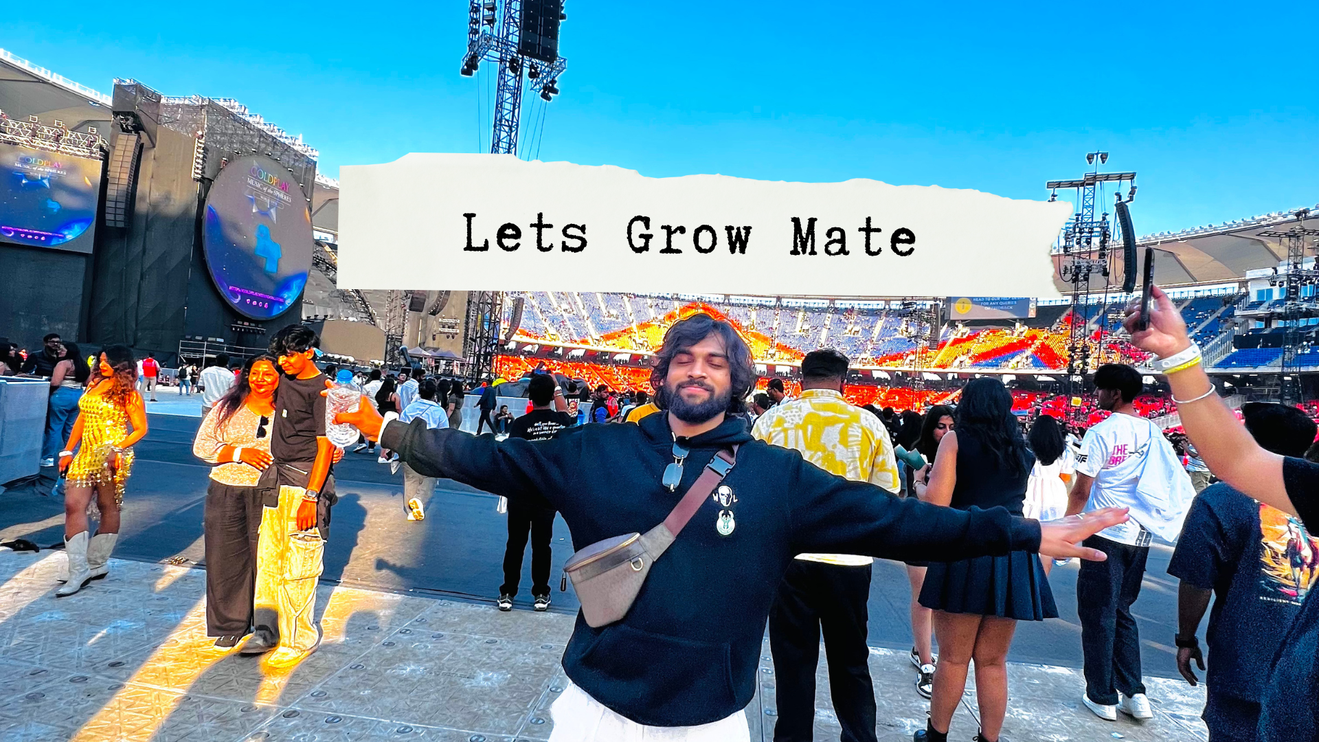 A group of young people in trendy clothes sitting on steps in front of a graffiti wall