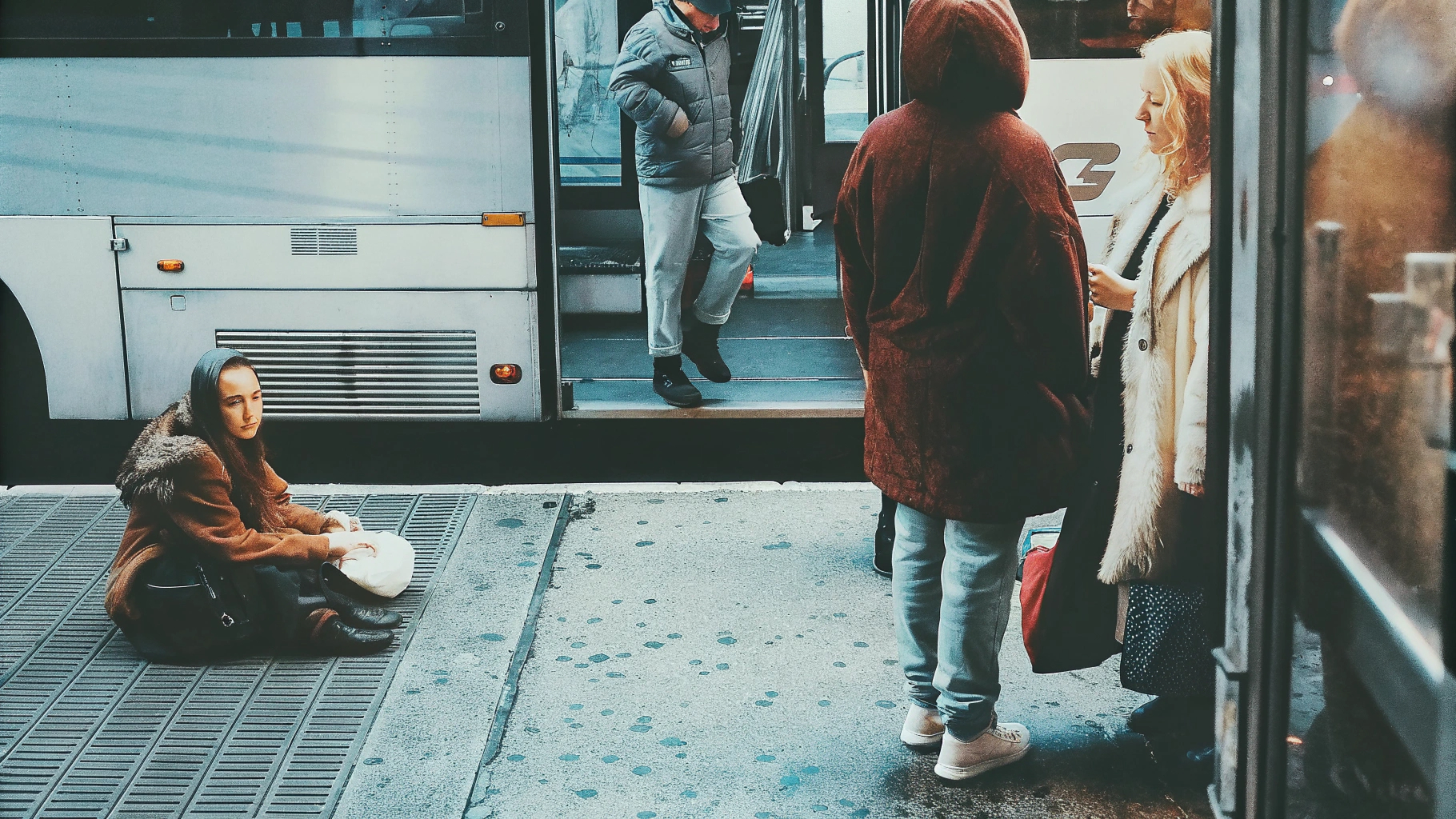 Woman seated near bus stop
