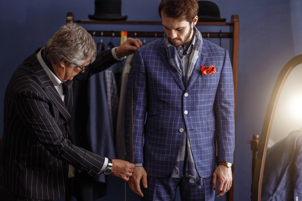 Tailor taking measurements