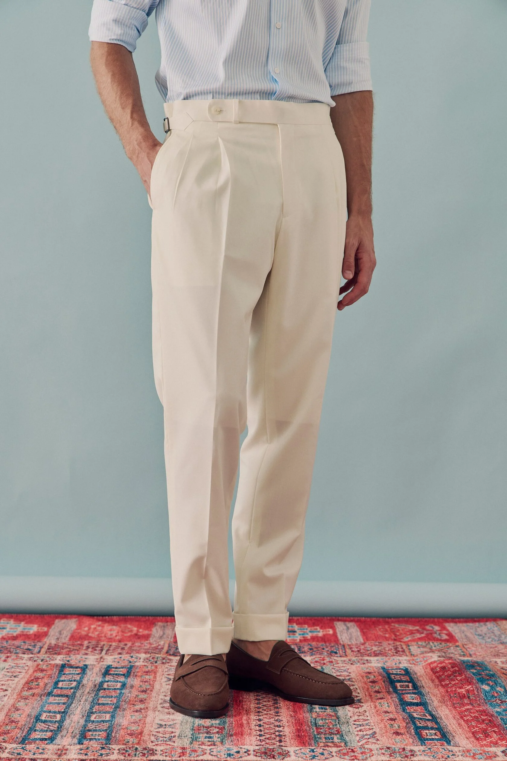 Cream pleated trousers with cuffs and side adjusters