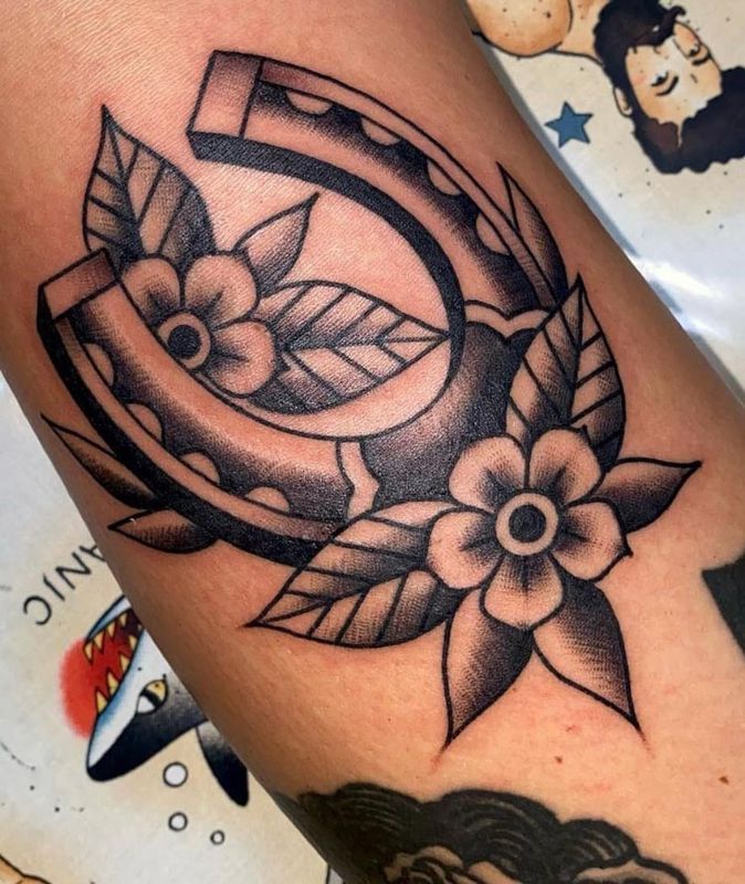 Horseshoe with flowers tattoo