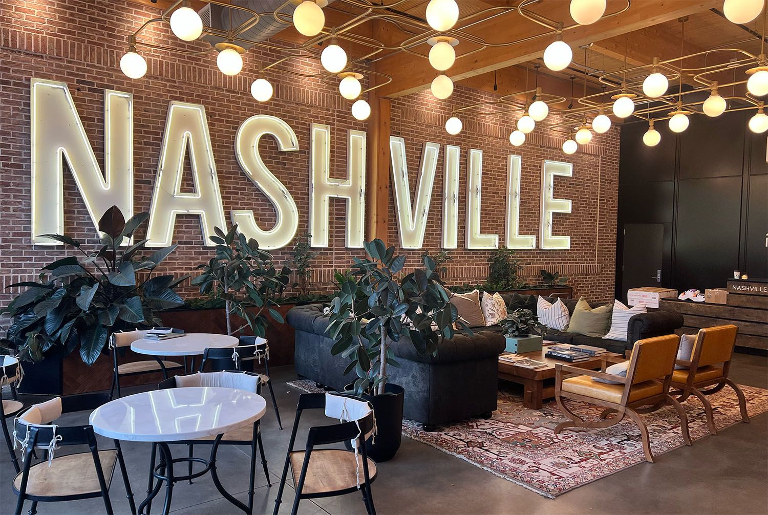Nashville interior with large illuminated sign and lounge seating