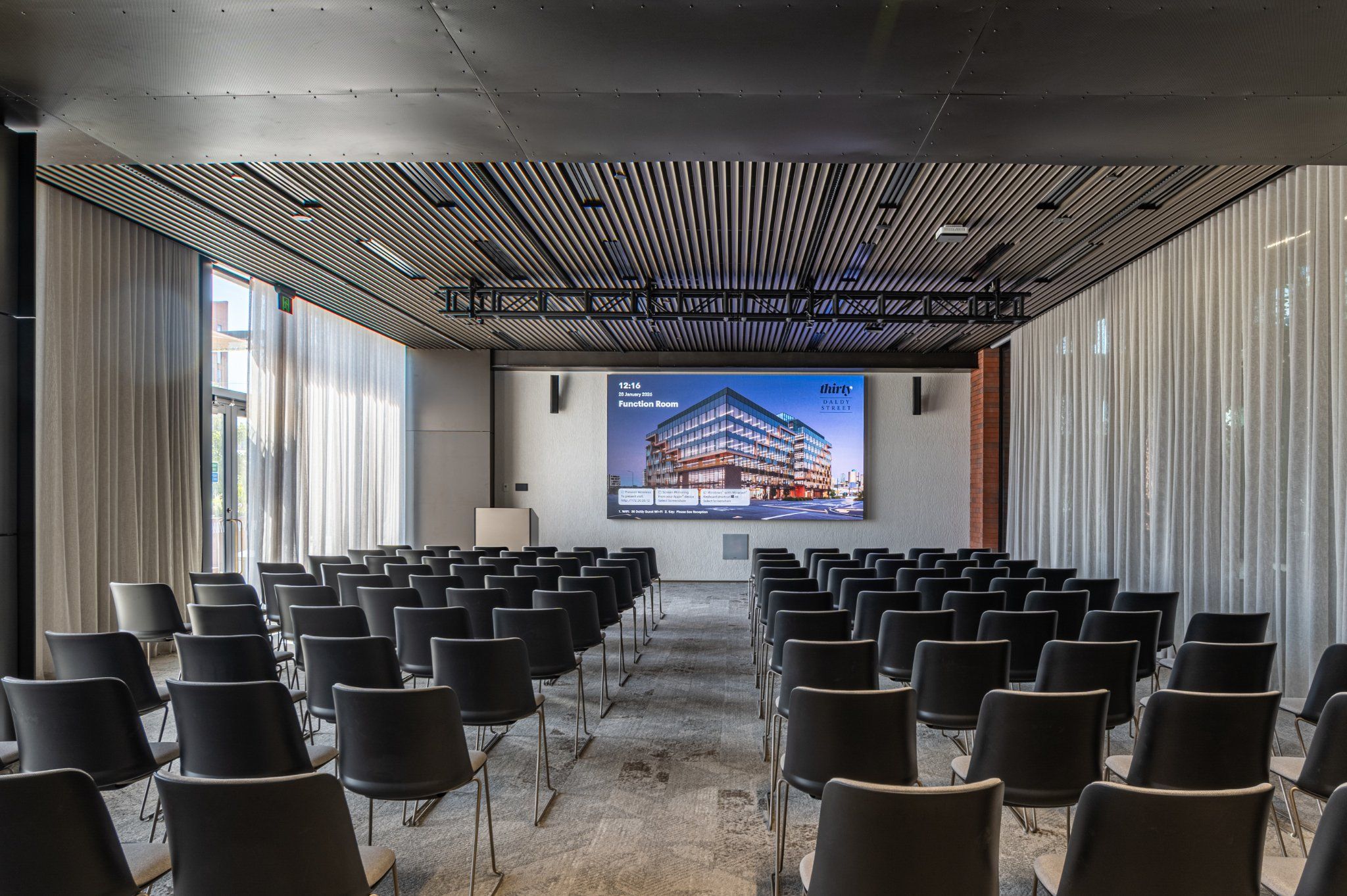 Function Room — full room view with projection screen and sheer curtains